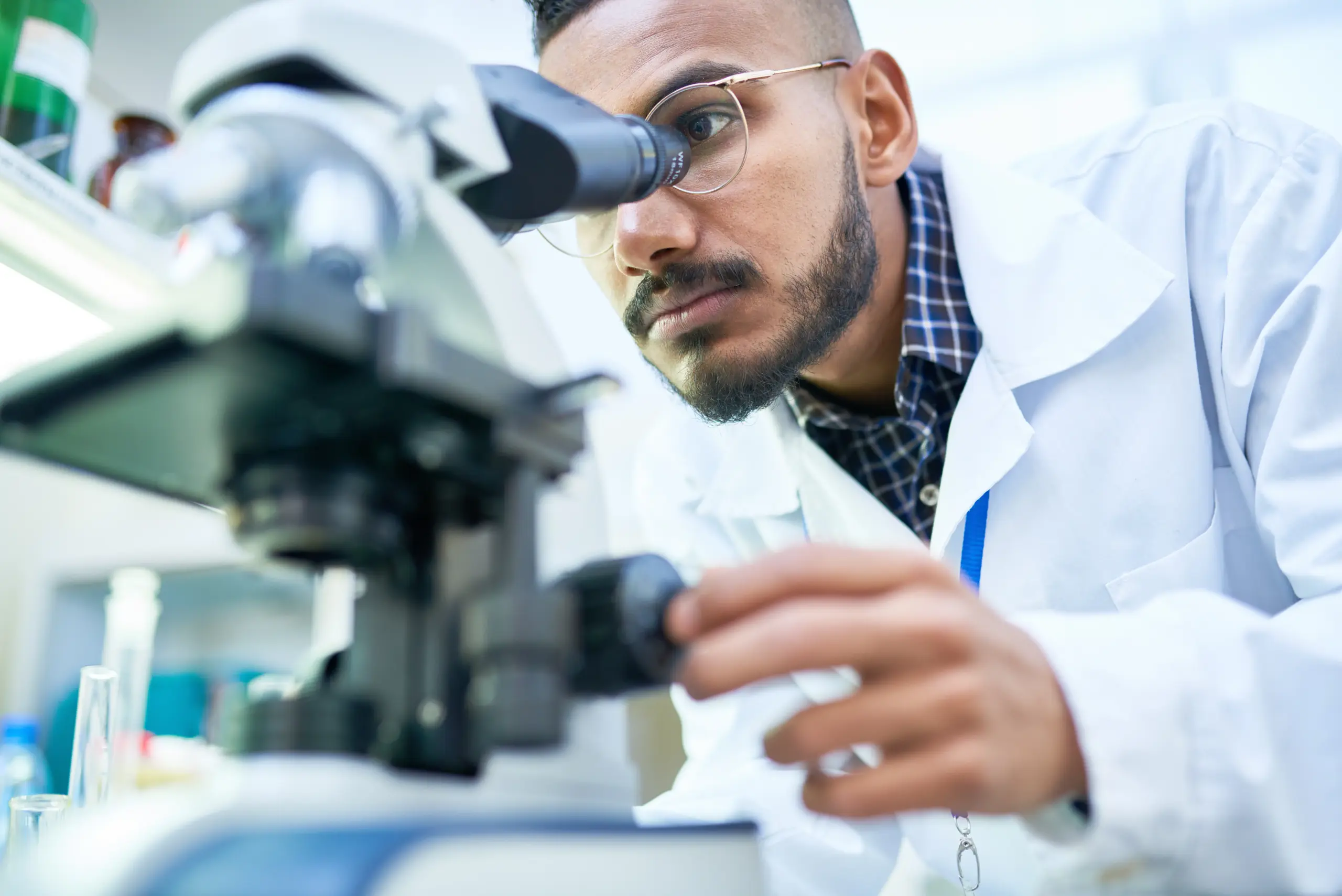 lab researcher with microscope scaled.jpeg scaled